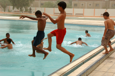 Iraqi children jump into the Al Jadida Public Swimming Pool after its ribbon-cutting ceremony in the Al Jadida district of Baghdad, Iraq, June 7, 2008. DoD photo by Staff Sgt. Brian D. Lehnhardt, U.S. Army. (Released