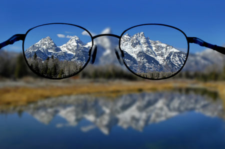 Glasses with clear vision of Teton Mountains in background